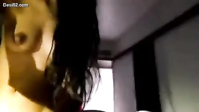 Indian aunty indulges in self-pleasure, spreading her hairy pussy in a tantalizing bathroom video.
