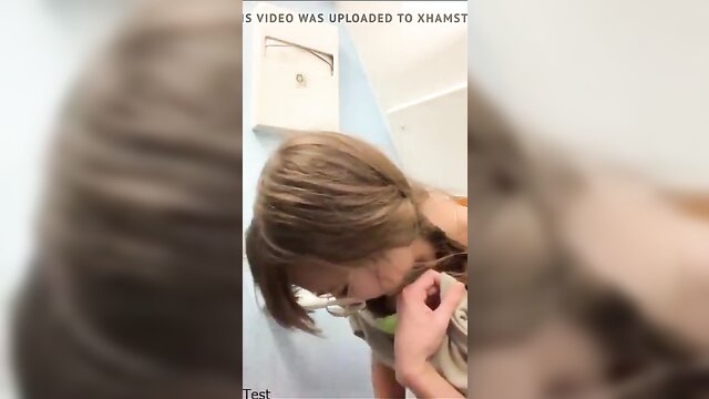 Close-up of a mature woman in a bathroom at the toilet, peeing into her mouth. XXX Tube.