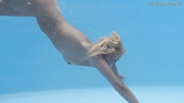 Russian amateur video of a seductive beauty diving into a pool, her body gracefully moving beneath the water. A tantalizing underwater erotic encounter unfolds, showcasing the passion and intimacy of lovers immersed in pleasure.
