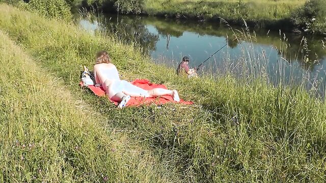 Wild beach. Sexy MILF Platinum naked sunbathing on river bank, random fisherman guy watches. Naked in public. Nude beach Sexy MILF Platinum naked sunbathing on river bank, random fisherman guy watches. Wild beach. Nude beach. Naked in public. Nudists. Naturists